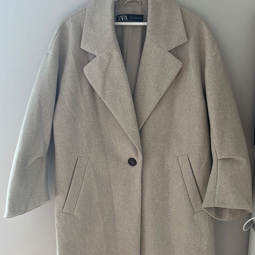 Oversized look. Great to wear over sweaters. No flaws